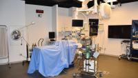 Mock O.R. with medical booms, surgical tables, laparoscopic towers, and medical gas connections.